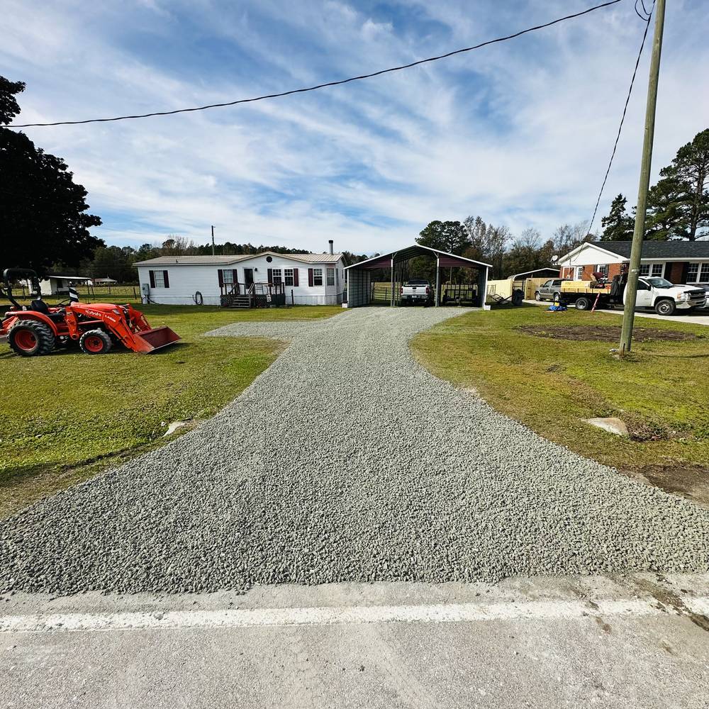 New gravel driveway leading to a home
