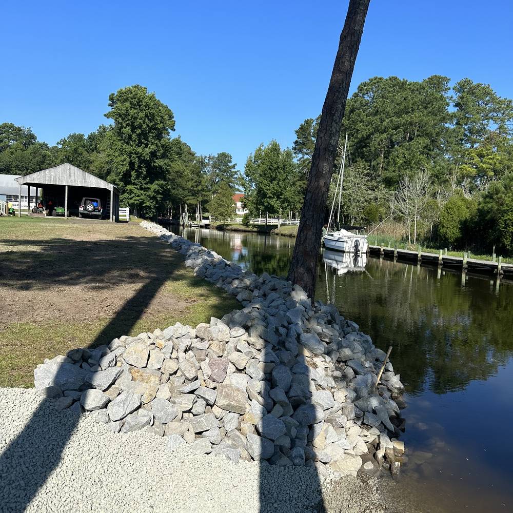 Riprap stone armoring at a canal bank